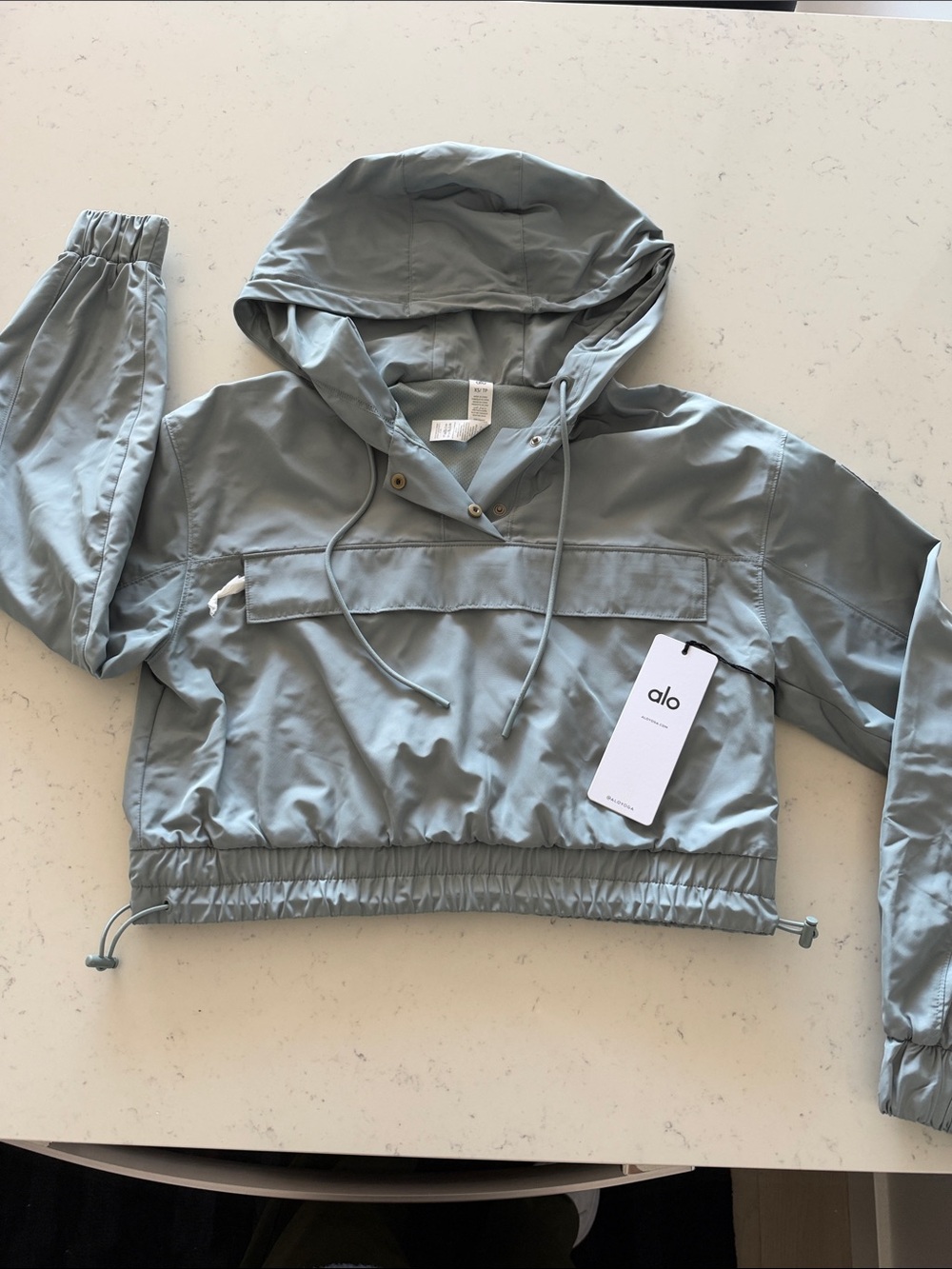 ALO Yoga Cropped Hooded Windbreaker in Sage Green